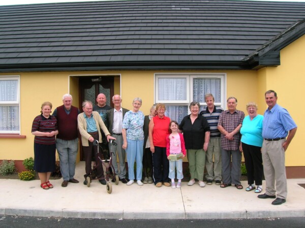 Tenants standing in front of a house